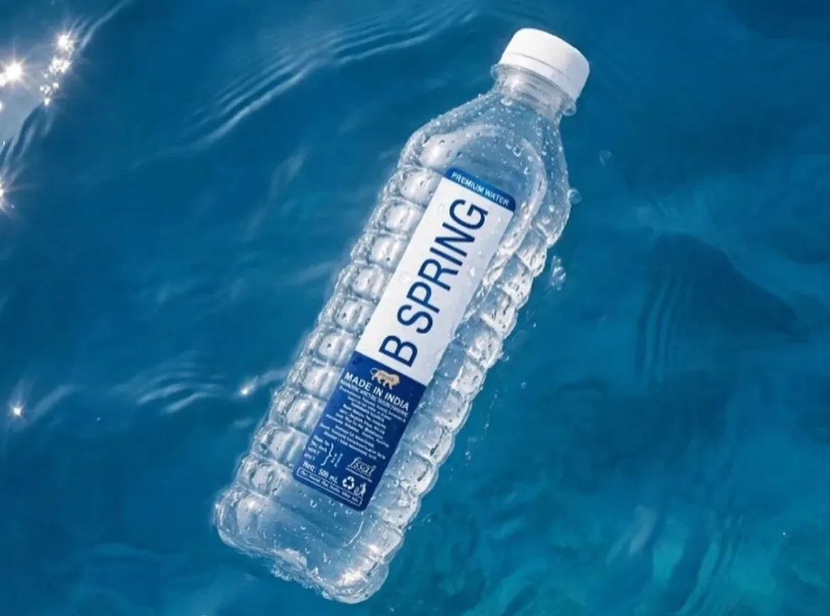 A B-Spring 500 mL bottle floating in clear blue water